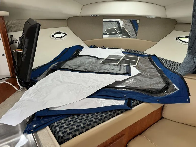 Slide: The Image of Interior of 2005 Bayliner 305 boat with cushions and window covers. - 13