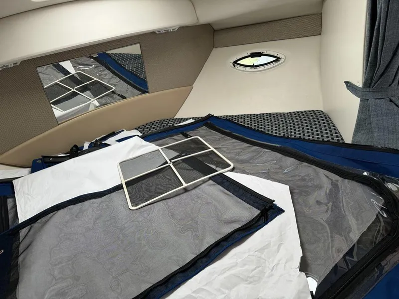 Slide: The Image of Interior cabin of a 2005 Bayliner 305 boat with window and fabric details. - 15