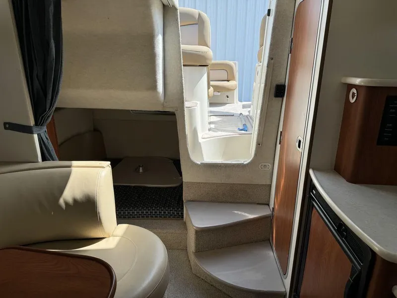 Slide: The Image of Interior of a 2005 Bayliner 305 boat, featuring seating and steps to the deck. - 19