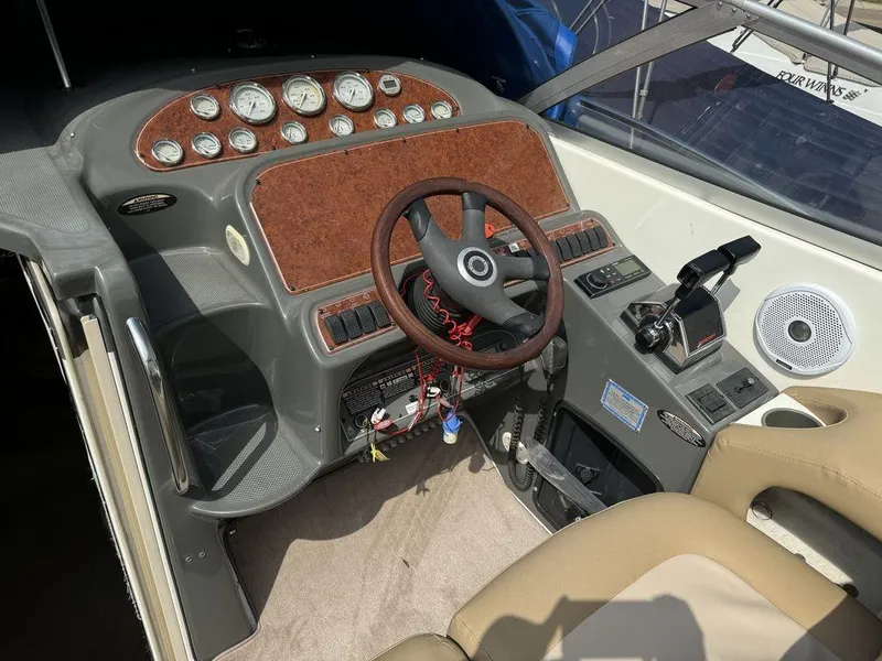 Slide: The Image of 2005 Bayliner 305 boat cockpit with steering wheel, gauges, and controls. - 4