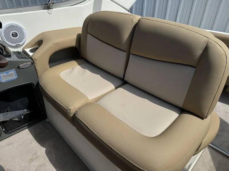 Slide: The Image of 2005 Bayliner 305 boat interior with beige seating and speaker. - 6