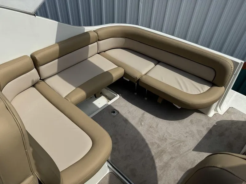 Slide: The Image of 2005 Bayliner 305 boat interior with beige seating and carpeted floor. - 8