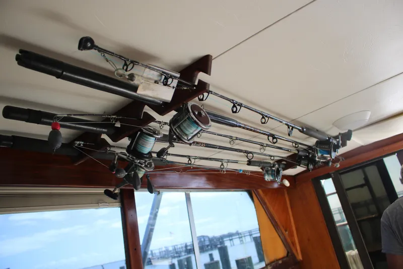 Slide: The Image of Fishing rods stored on a 1974 Viking Boats 40 Sport fish interior ceiling. - 11