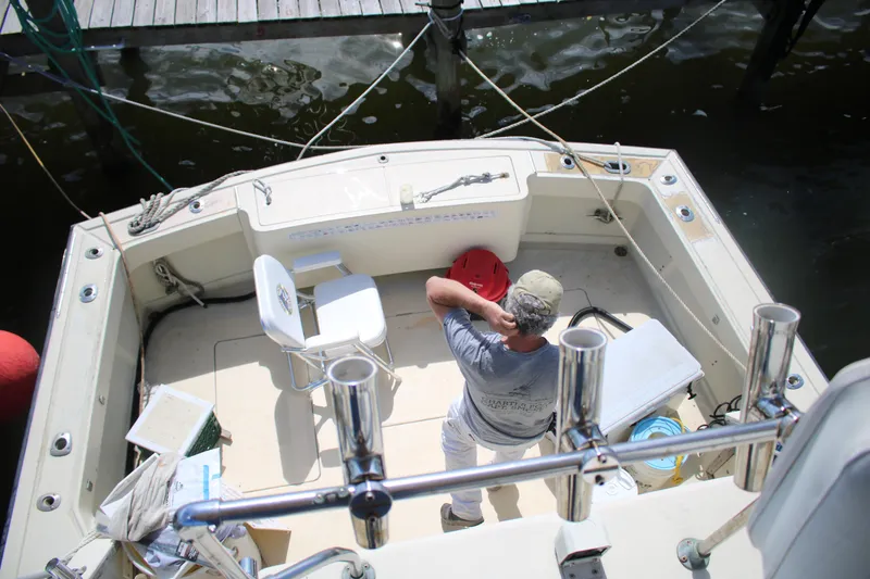 Slide: The Image of Man on 1974 Viking Boats 40 Sport Fish, preparing equipment at dockside. - 17