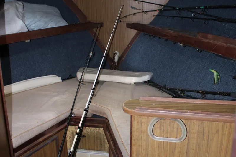 Slide: The Image of Interior of 1974 Viking Boats 40 Sport Fish with fishing rods and cozy sleeping area. - 26