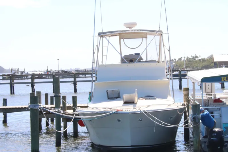 Slide: The Image of 1974 Viking Boats 40 Sport Fish docked at a marina, front view. - 27