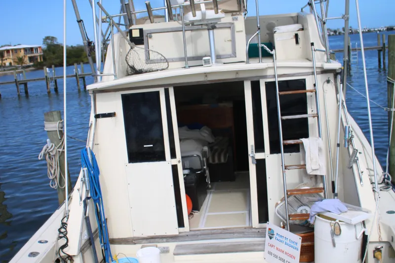 Slide: The Image of 1974 Viking Boats 40 Sport Fish at dock, rear view with open cabin. - 28