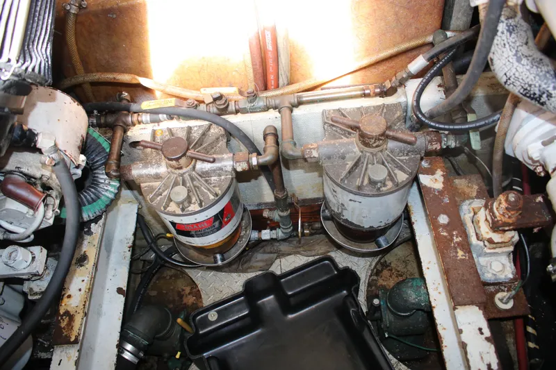 Slide: The Image of Engine room of 1974 Viking Boats 40 Sport Fish, showing fuel filters and mechanical components. - 8