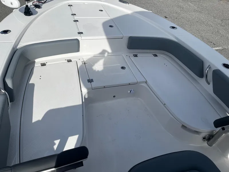 Slide: The Image of 2025 Robalo 246 Cayman boat interior with spacious seating and storage compartments. - 17