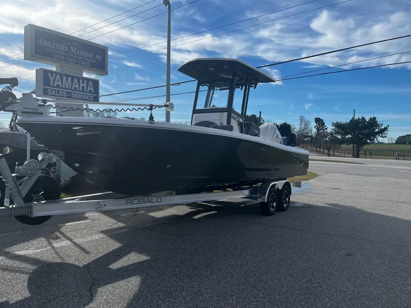 Slide: The Image of 2025 Robalo 246 Cayman boat on trailer at Anglers Marine NC dealership. - 2