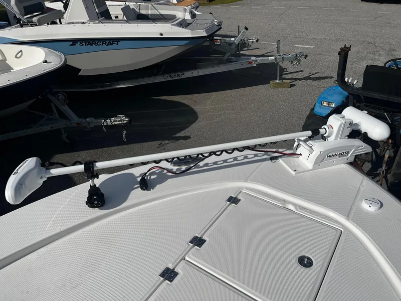 Slide: The Image of 2025 Robalo 246 Cayman boat with Minn Kota trolling motor on deck. - 22