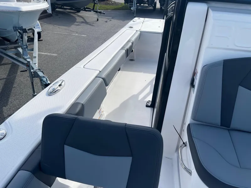 Slide: The Image of 2025 Robalo 246 Cayman boat interior with gray seating and spacious deck layout. - 23