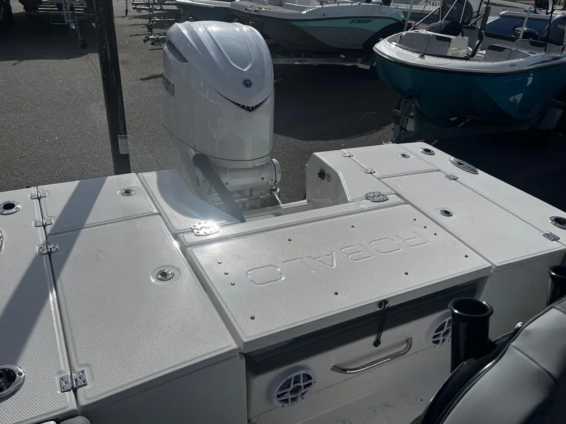 Slide: The Image of 2025 Robalo 246 Cayman boat with Yamaha outboard engine, docked in a marina. - 9