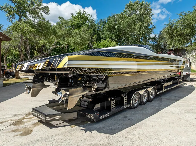 Slide: The Image of High-performance 2017 MTI 48 speedboat on trailer, featuring sleek design and powerful engines. - 20