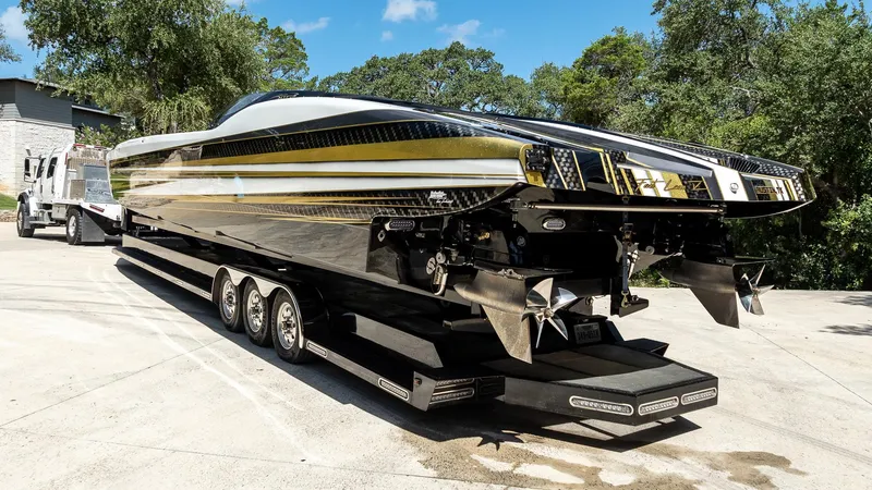 Slide: The Image of 2017 MTI 48 powerboat on trailer, featuring sleek design and multiple propellers. - 22