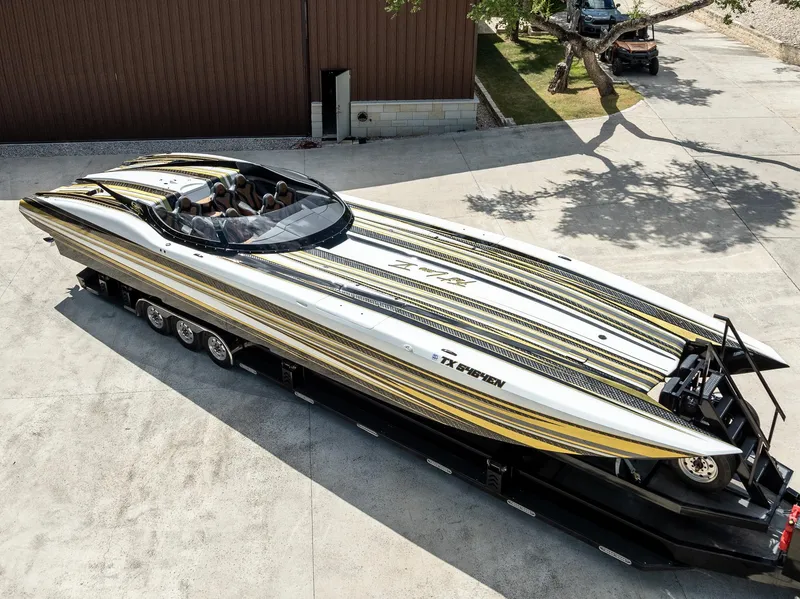Slide: The Image of 2017 MTI 48 speedboat with sleek yellow and black stripes on a trailer. - 33