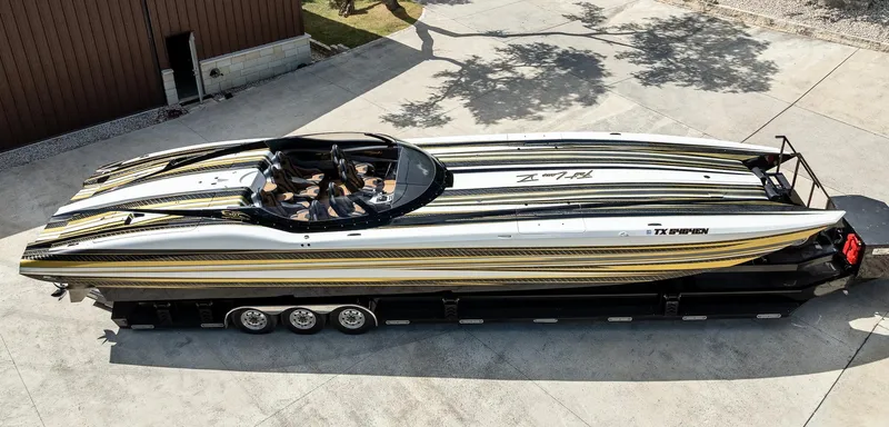 Slide: The Image of 2017 MTI 48 speedboat with sleek black and yellow design on a trailer. - 35