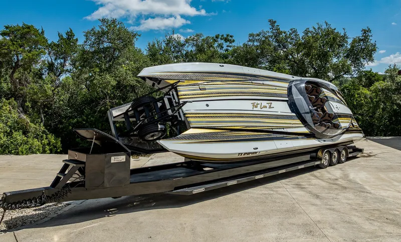Slide: The Image of 2017 MTI 48 powerboat on trailer, featuring sleek design and vibrant stripes. - 39