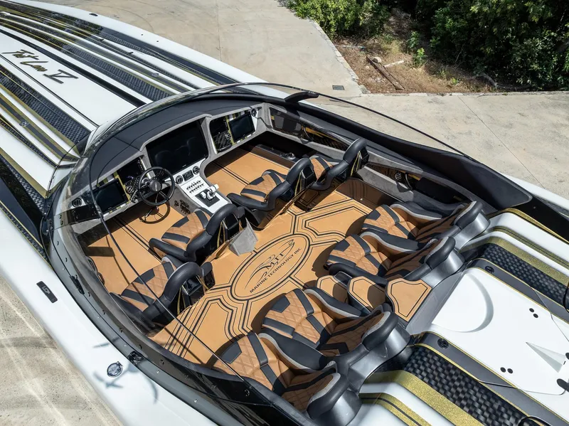 Slide: The Image of Luxurious 2017 MTI 48 speedboat interior with sleek seating and advanced dashboard controls. - 44