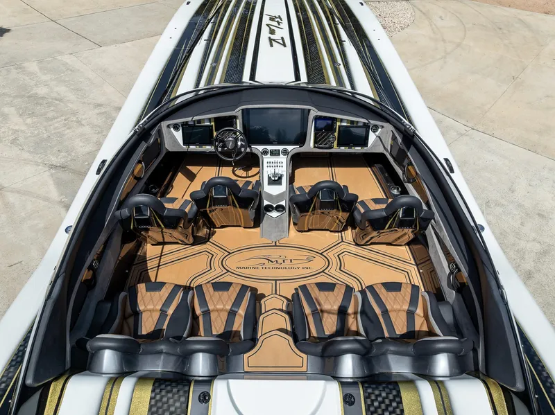 Slide: The Image of Luxurious 2017 MTI 48 boat interior with sleek seating and advanced dashboard controls. - 45