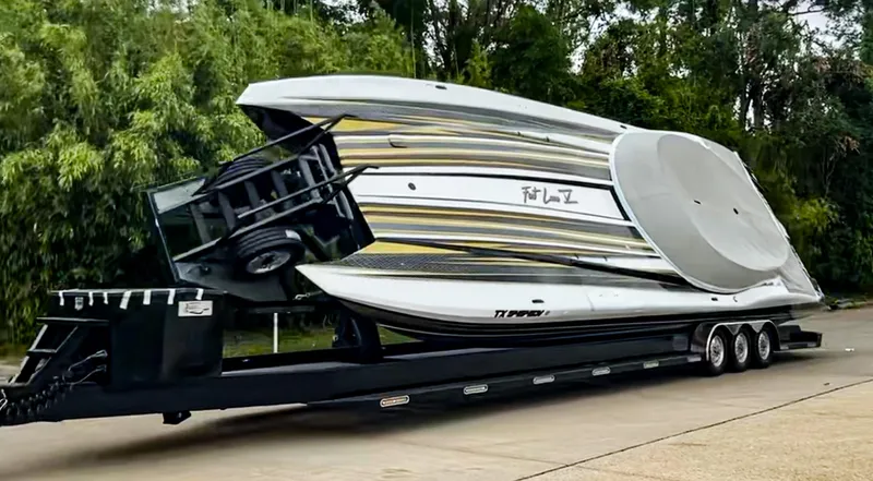 Slide: The Image of 2017 MTI 48 boat on trailer, sleek design, parked outdoors. - 5