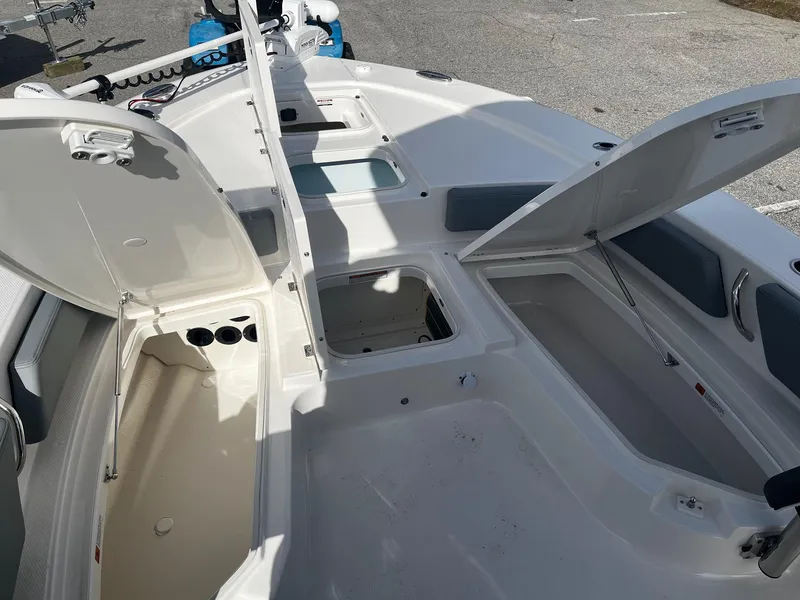 Slide: The Image of 2025 Robalo 246 Cayman boat interior with open storage compartments and seating. - 18