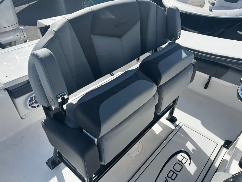 Slide: The Image of 2025 Robalo 246 Cayman boat seating, featuring modern, cushioned dual seats with armrests. - 24