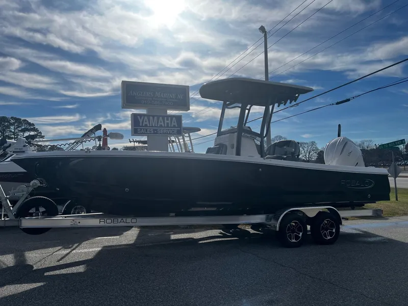 Slide: The Image of 2025 Robalo 246 Cayman boat on trailer under cloudy sky at Yamaha sales location. - 25