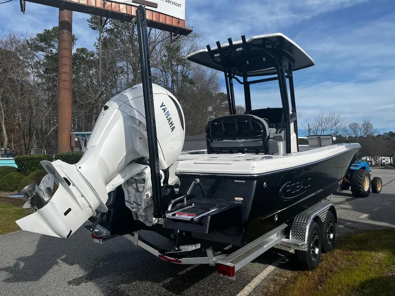 Slide: The Image of 2025 Robalo 246 Cayman boat with Yamaha engine on a trailer, parked outdoors. - 4