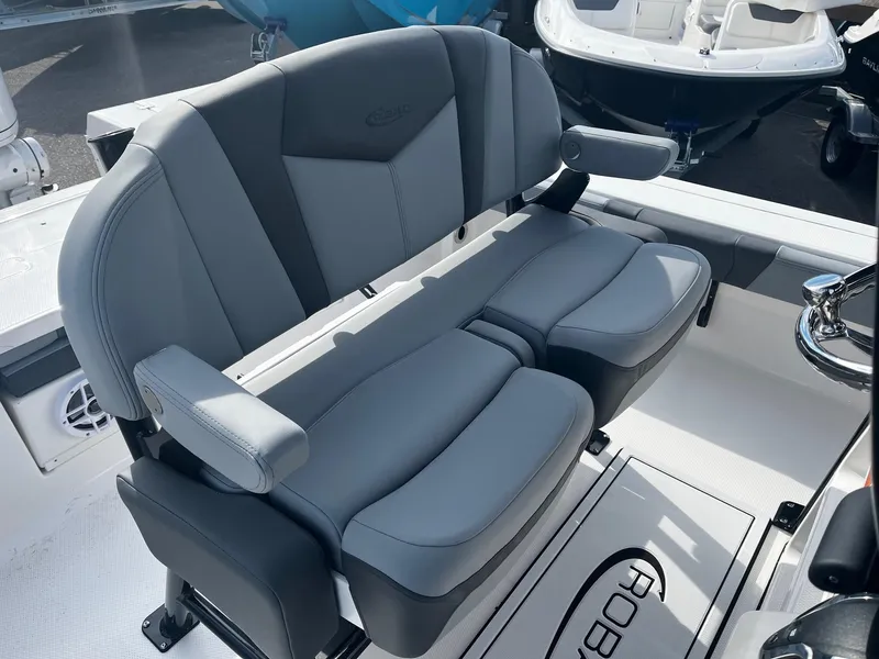 Slide: The Image of 2025 Robalo 246 Cayman boat interior with dual gray seats and armrests. - 12