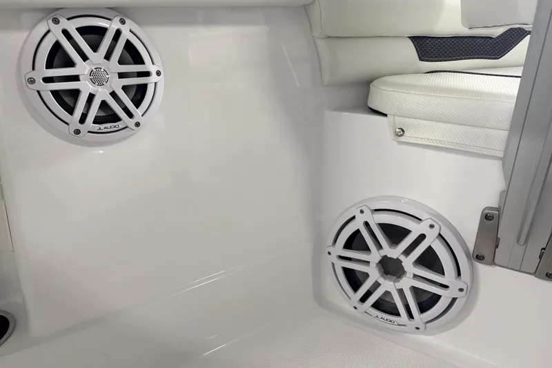 Slide: The Image of 2025 Wellcraft 223 Fisherman boat interior with JL Audio speakers and cushioned seating. - 13