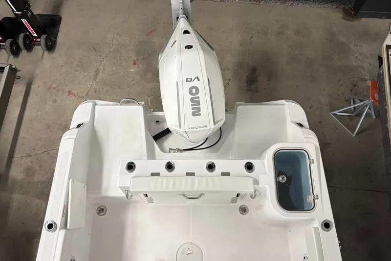 Slide: The Image of 2025 Wellcraft 223 Fisherman boat with outboard motor, viewed from above in a garage setting. - 15