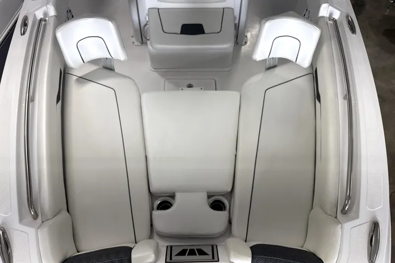 Slide: The Image of 2025 Wellcraft 223 Fisherman boat interior with white cushioned seating and stainless steel railings. - 4