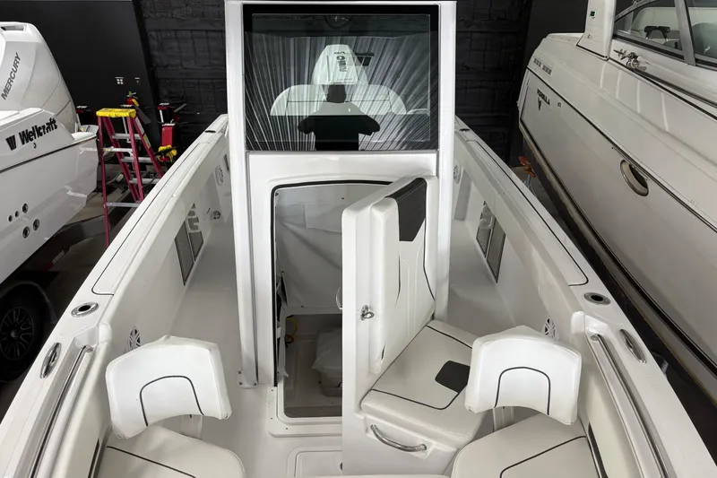 Slide: The Image of 2025 Wellcraft 223 Fisherman boat interior with seating and storage compartments. - 8