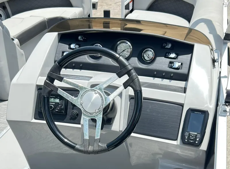 Slide: The Image of Steering console of 2021 Bennington L 24 Swingback pontoon boat with gauges and controls. - 12