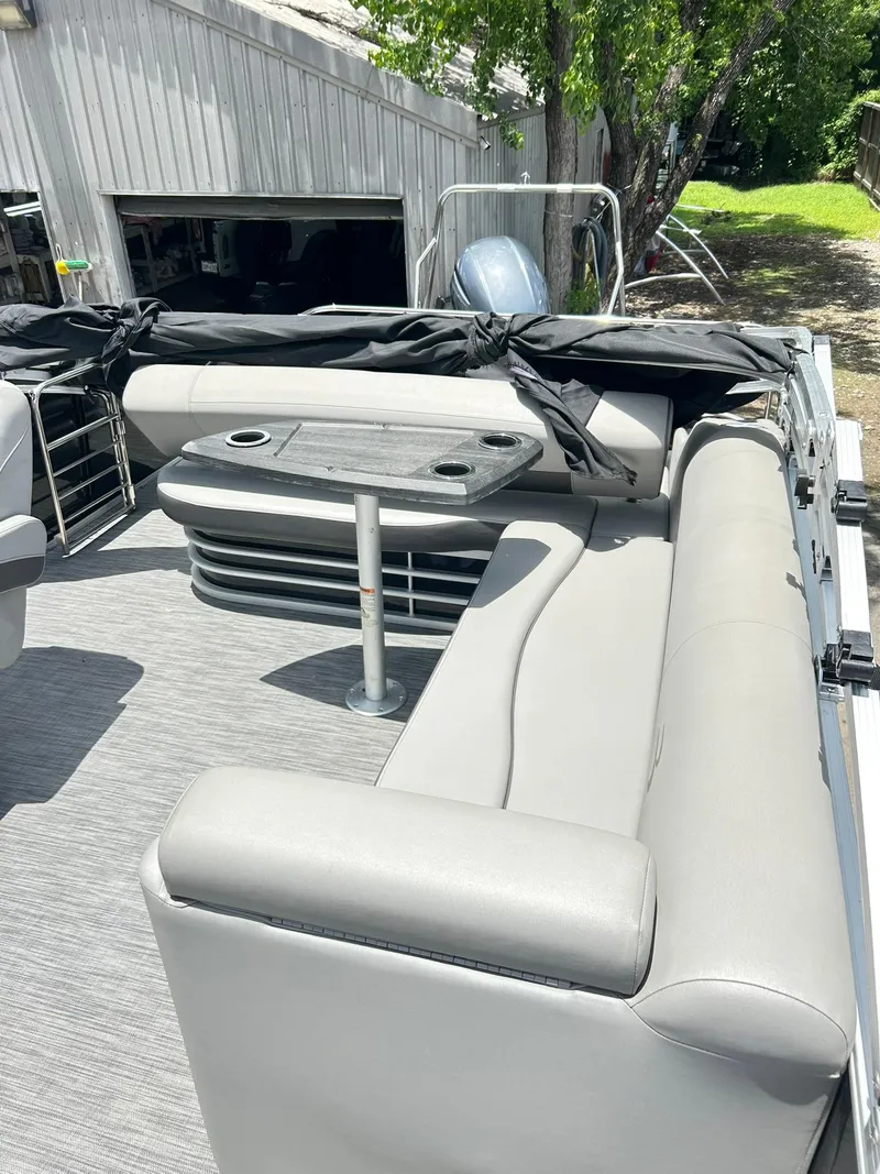 Slide: The Image of 2021 Bennington L 24 Swingback pontoon boat with gray seating and table. - 15