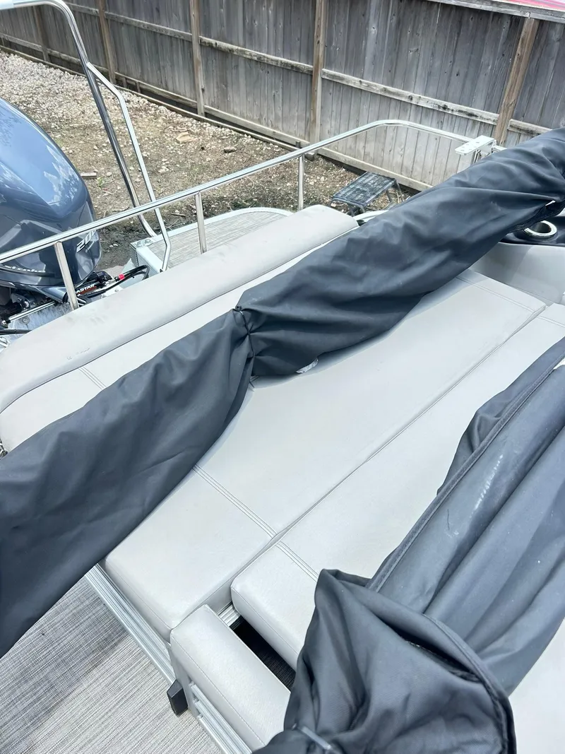 Slide: The Image of 2021 Bennington L 24 Swingback boat with covered seating and railing. - 17