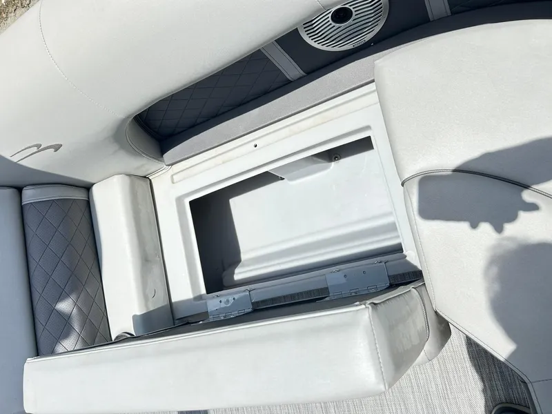 Slide: The Image of Open storage compartment on 2021 Bennington L 24 Swingback boat with cushioned seating. - 19