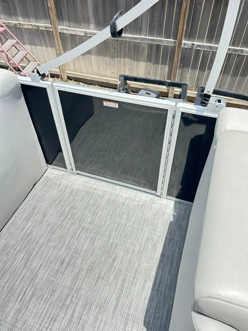 Slide: The Image of 2021 Bennington L 24 Swingback interior with gray flooring and seating. - 20