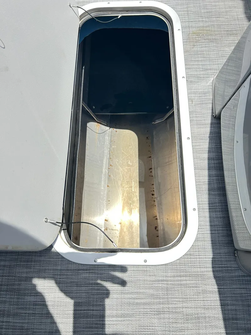 Slide: The Image of Open storage compartment on 2021 Bennington L 24 Swingback boat deck. - 23
