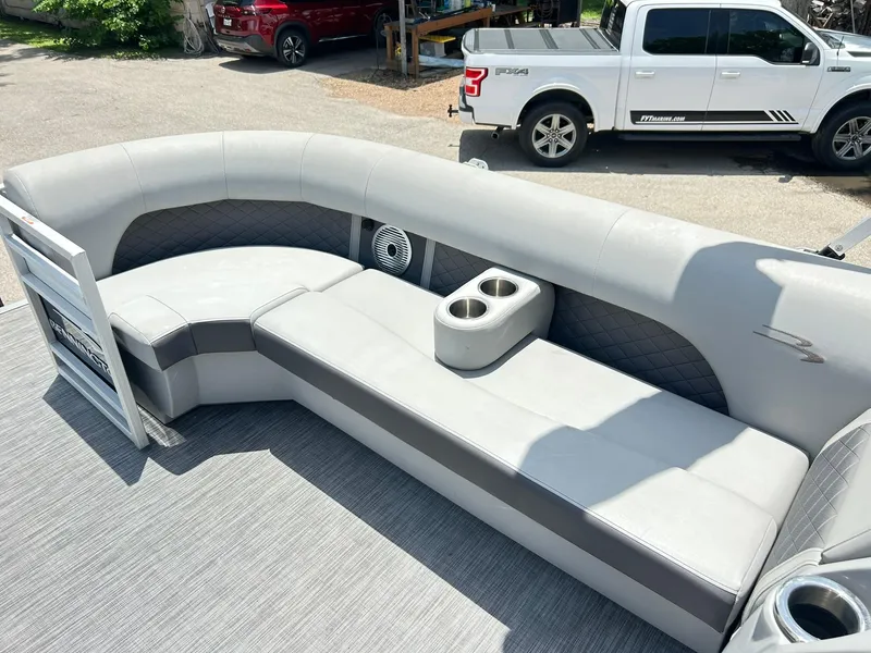Slide: The Image of 2021 Bennington L 24 Swingback boat interior with gray seating and cup holders. - 25