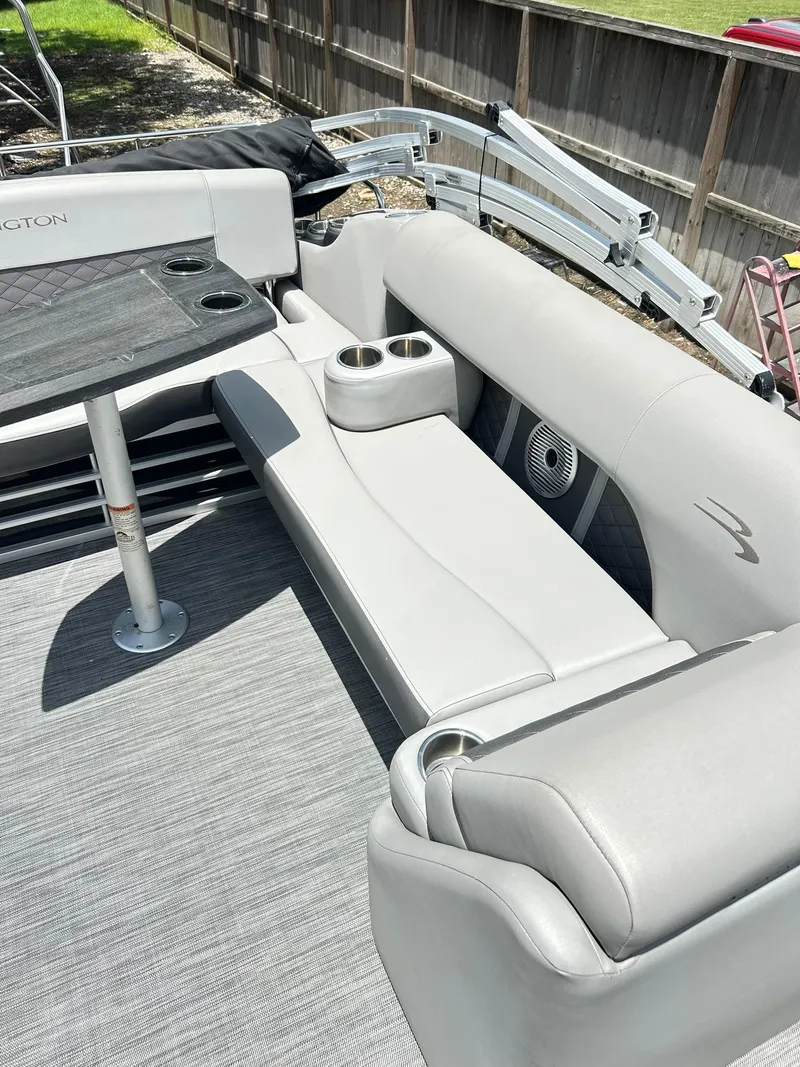 Slide: The Image of 2021 Bennington L 24 Swingback boat interior with gray seating and table. - 27