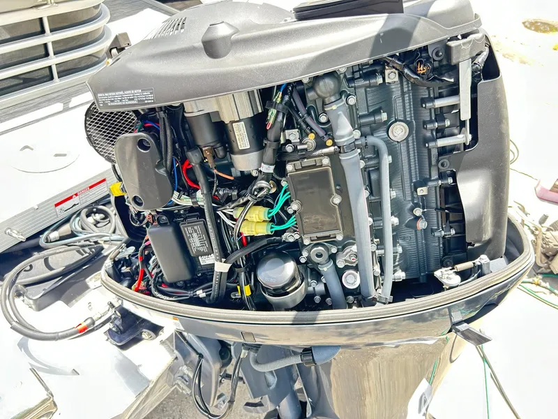 Slide: The Image of Open engine of a 2021 Bennington L 24 Swingback boat, showcasing intricate mechanical components. - 39