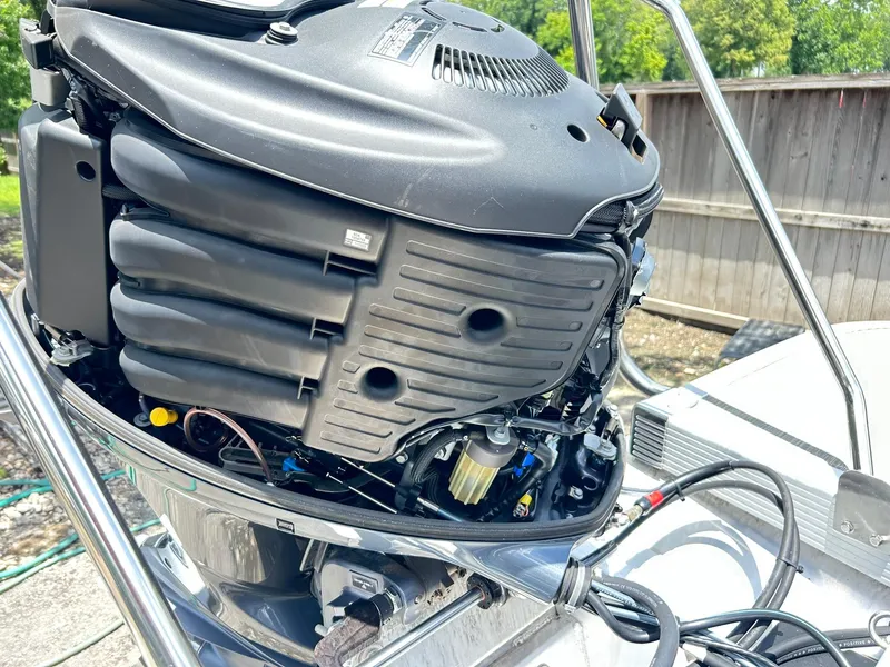 Slide: The Image of 2021 Bennington L 24 Swingback boat engine with open cover, showing internal components. - 40