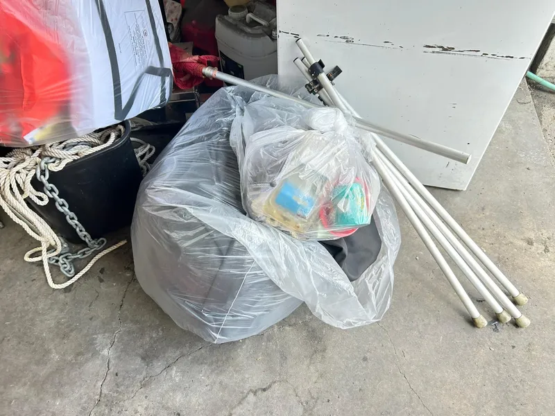 Slide: The Image of Plastic bags and poles on concrete floor, near ropes and chains. Bennington L 24 Swingback 2021. - 43