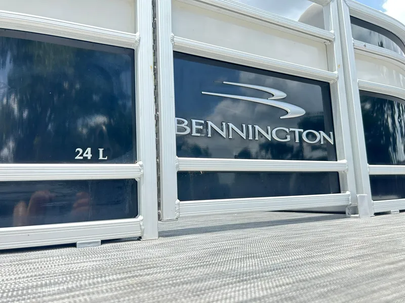Slide: The Image of 2021 Bennington L 24 Swingback pontoon boat, close-up of logo and model details. - 5