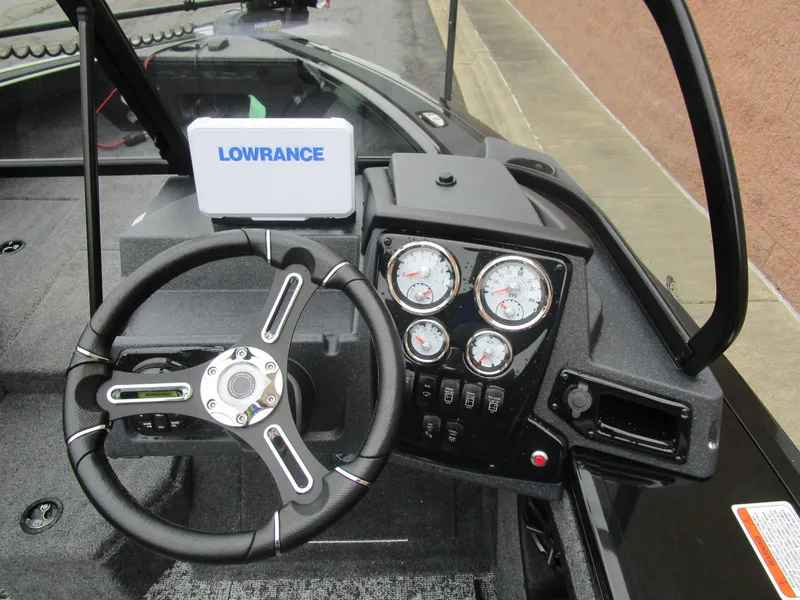 Slide: The Image of 2026 Tracker Targa 18 WT dashboard with steering wheel and Lowrance display. - 11