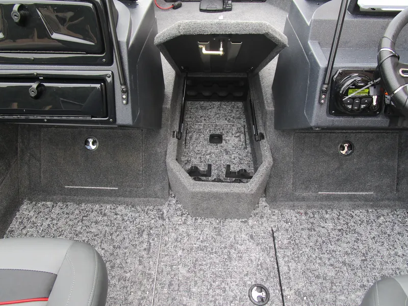 Slide: The Image of Interior of 2026 Tracker Targa 18 WT boat showing storage compartments and dashboard. - 13