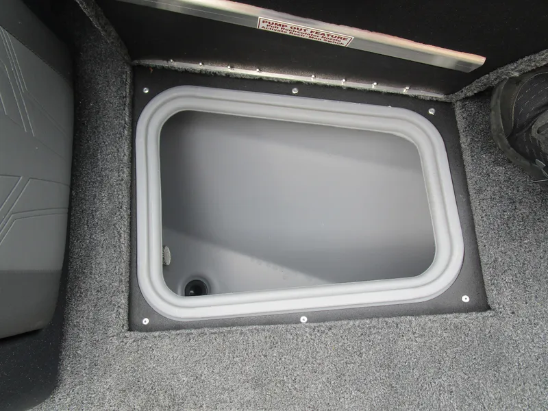 Slide: The Image of 2026 Tracker Targa 18 WT boat storage compartment with gray interior. - 16