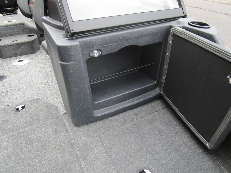 Slide: The Image of 2026 Tracker Targa 18 WT boat interior storage compartment with open door and cup holder. - 17